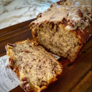 Maple Pecan Banana Bread and slices on a wooden table