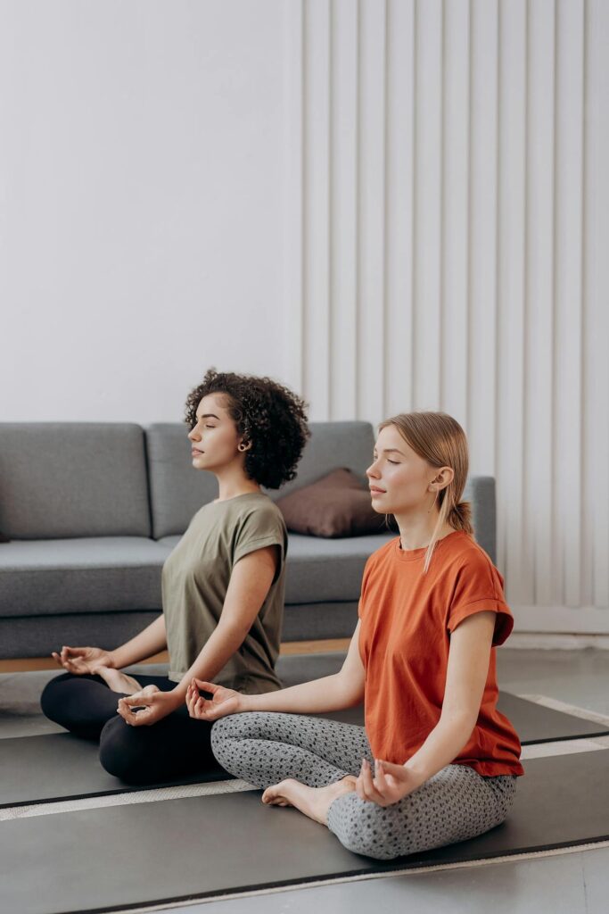 Mia & Samantha the founders of She Coox playing yoga