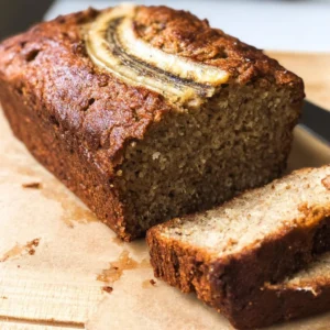 Deliciously moist vegan banana bread sliced on a wooden board