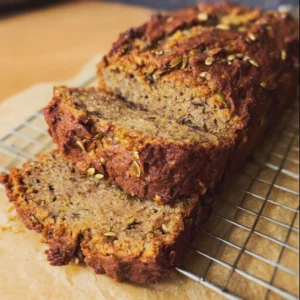 Delicious slice of vegan banana bread on a wooden table