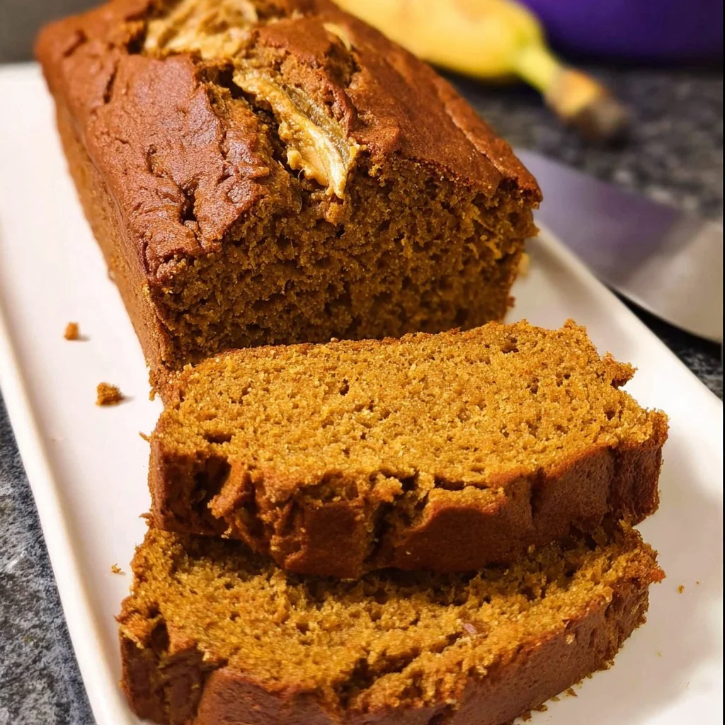 Vegan pumpkin banana bread served on a rustic wooden table