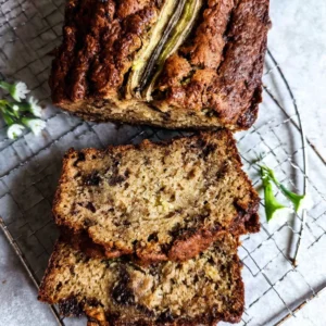 Delicious vegan zucchini banana bread on a wooden table