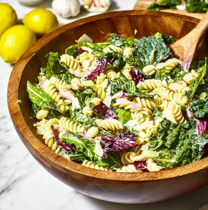 Creamy lemon pasta salad with fresh ingredients and vibrant colors.