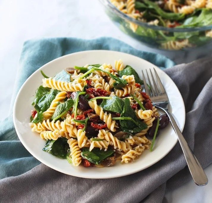 Fresh vibrant pasta salad with colorful vegetables and dressing