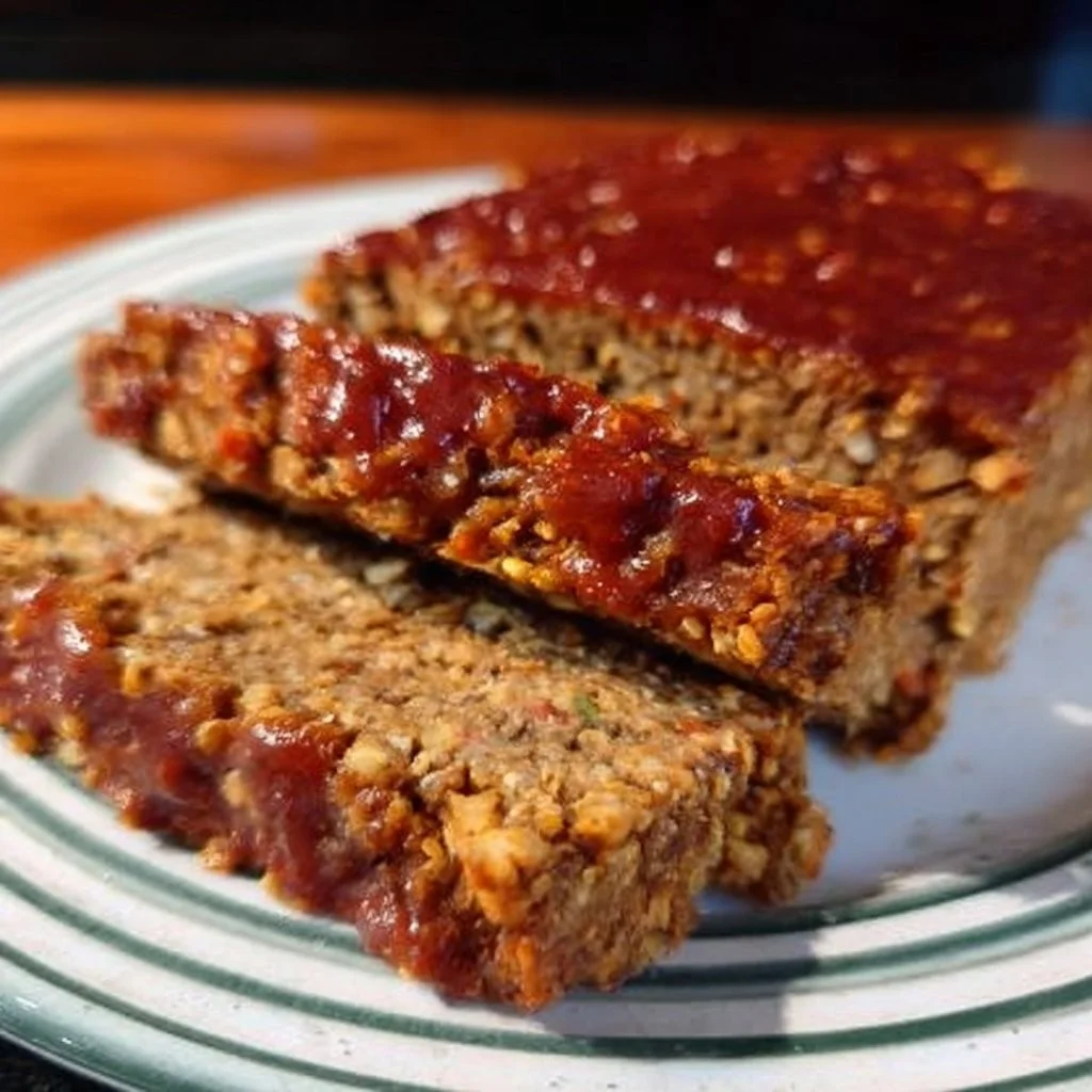 Delicious Vegan Lentil Quinoa Loaf served on a plate with fresh herbs